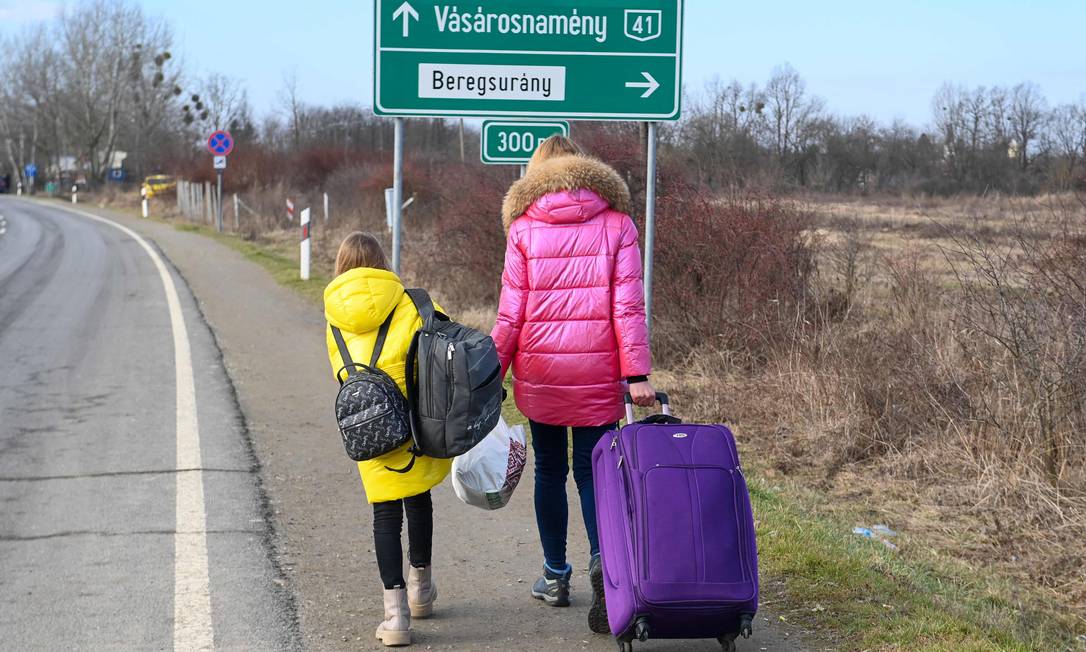 97776480 A Ukrainian mother walks with her daughter along the road from the Hungarian Ukrainian bord